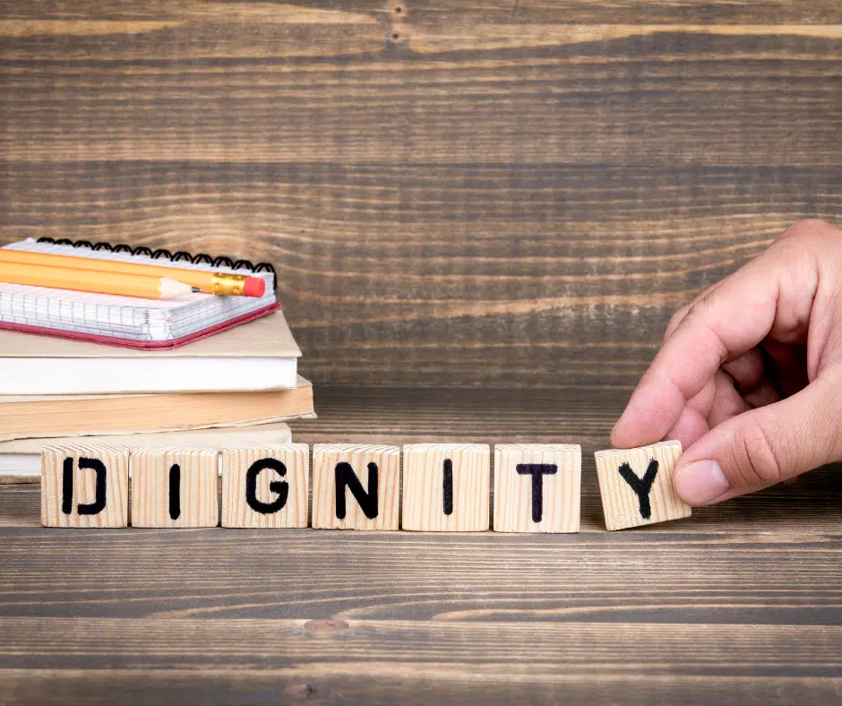 The word "dignity" is spelled out with blocks.